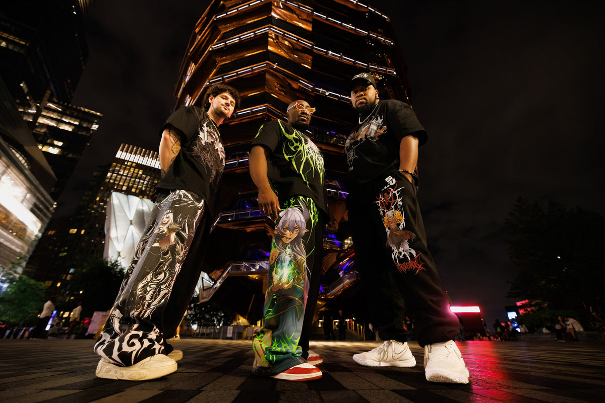 Three models wearing U.K.O October drop shirts and pants at night